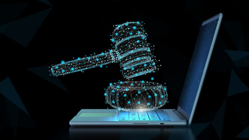 A computer-generated gavel hovering over a laptop.