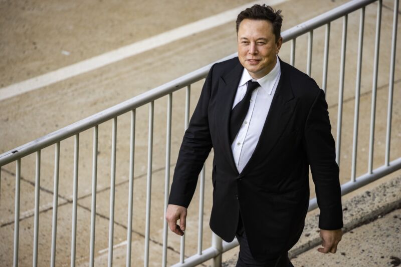 Elon Musk wearing a suit as he leaves a courthouse during a trial in 2021.