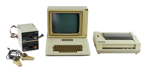 Julien is auctioning an Apple II Plus ('78-'82) with a monitor, printer, two disk drives, two gaming paddles, and a manual. 