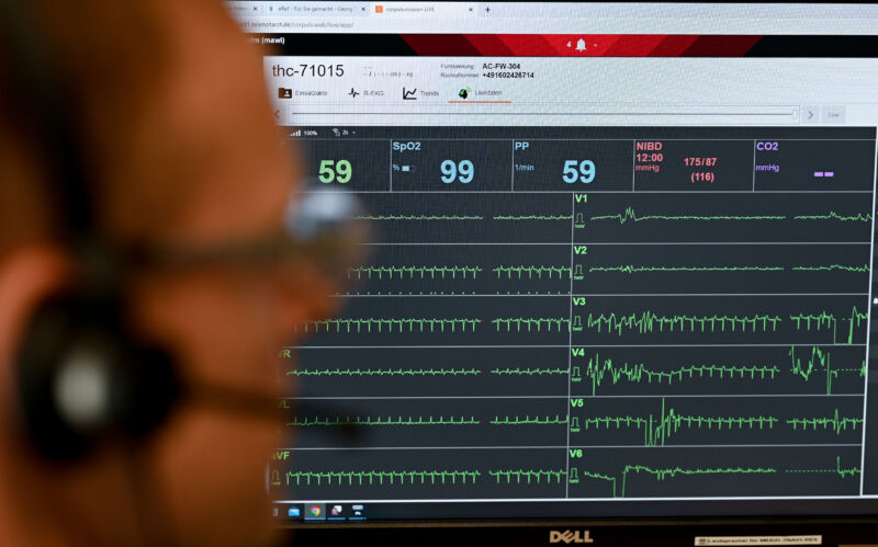 A medical director in Germany sits in front of a monitor showing the real-time data of a patient with a heart attack. 