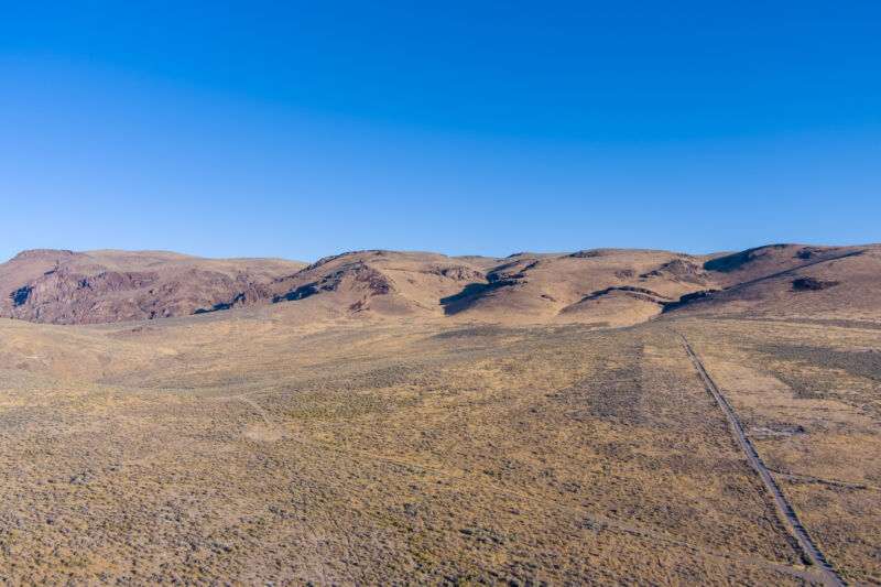 Aerial view of a dirt road leading up through The Thacker Pass Lithium mining area in the arid Nevada desert.