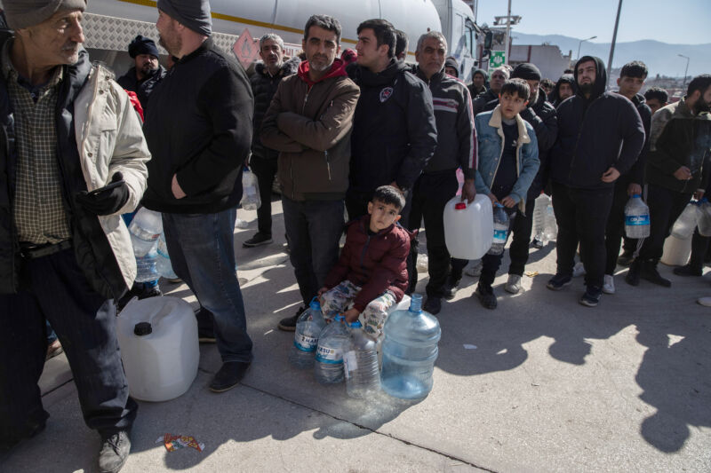 People queue for drinking water on February 9, 2023 in Hatay, Turkey.