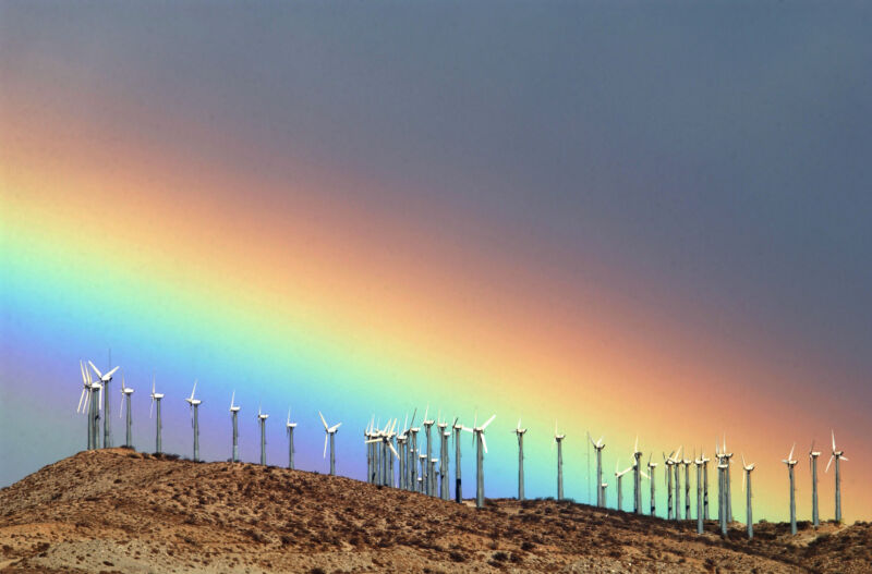 The first storm of the season produces a rainbow behind wind turbines on a hill in Palm Springs, California