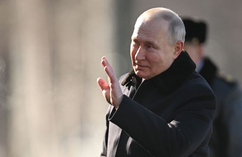 Russian President Vladimir Putin waves at an event.