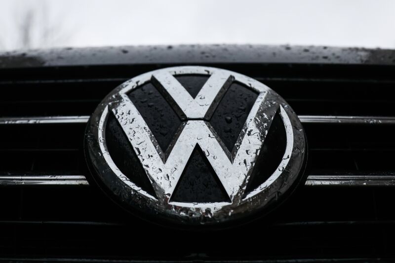 A Volkswagen logo on a car grille.