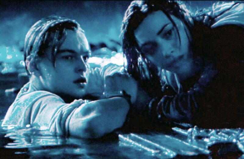 Jack (Leonardo DiCaprio) sacrifices his spot on a makeshift raft to save Rose (Kate Winslet) in <em>Titanic</em>.