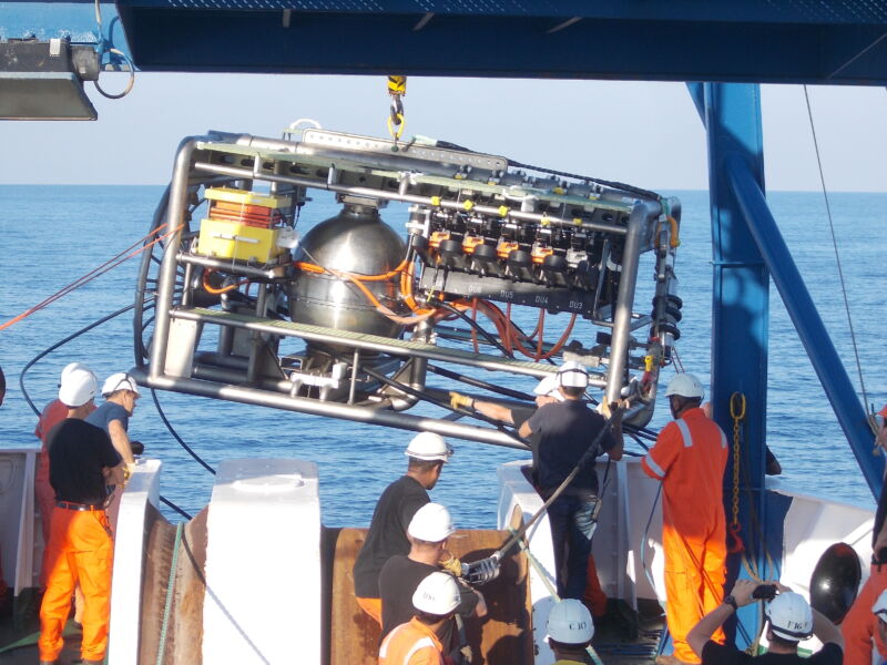 Image of a collection of hardware being hosted over a ship's side.
