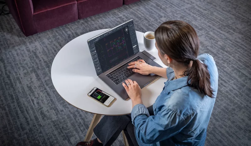 A woman uses AutoCAD on a MacBook Pro in this promotional image from Autodesk.