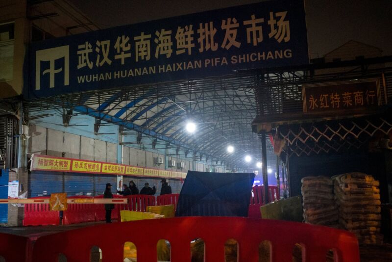 Security guards stand in front of the closed Huanan Seafood Wholesale Market in the city of Wuhan, in the Hubei Province, on January 11, 2020, where the Wuhan health commission said that the man who died from a respiratory illness had purchased goods. 