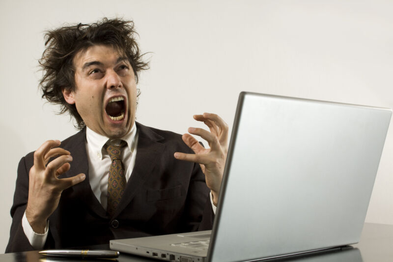 A person screaming at his computer.