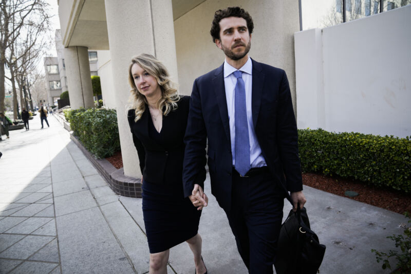 Former Theranos CEO Elizabeth Holmes, alongside her partner Billy Evans, leaves a hearing at the Robert E. Peckham US Courthouse on March 17 in San Jose, California.