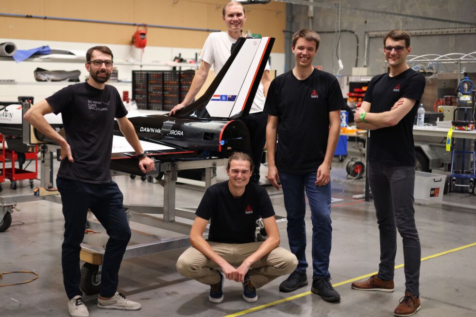 The founders of Dawn Aerospace with the Mk-II Aurora. Stefan Powell is in the center of the photo, squatting down.