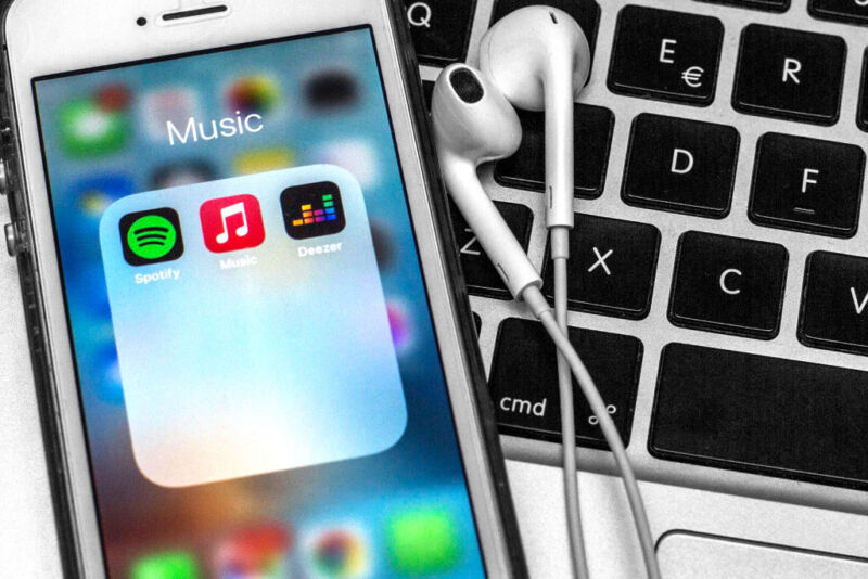 iPhone with music apps and earbuds