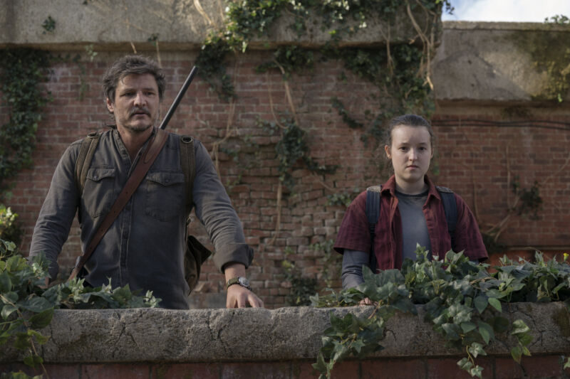 Pedro Pascal and Bella Ramsey stand in the ruins of a city