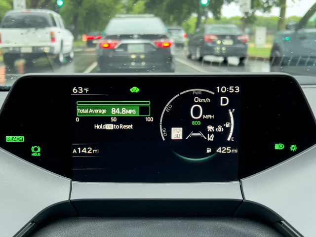 A Toyota Prius main instrument display showing 84 mpg