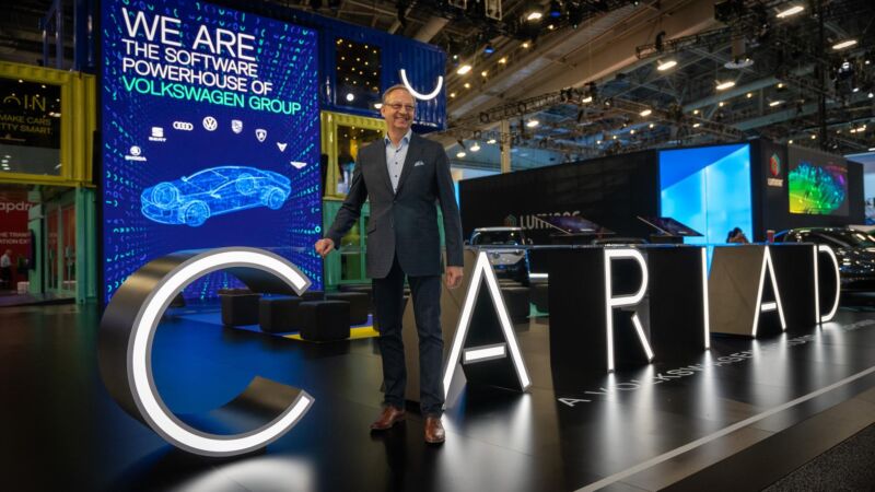 Dirk Hilgenberg stands next to a CARIAD sign at CES