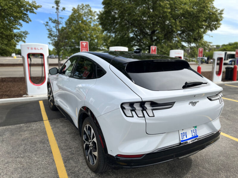 A Ford Mustang Mach-E at a Tesla Supercharger