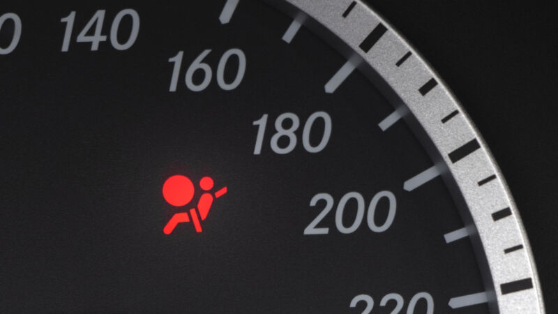 Red lighting air bag control symbol in car