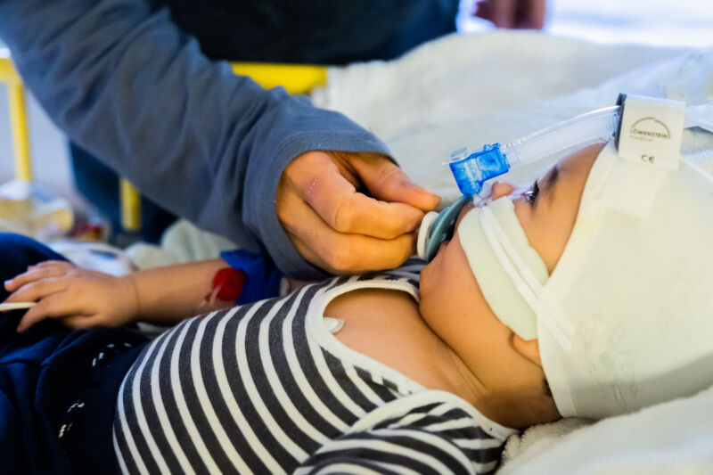 A father cares for his eight-and-a-half-month-old son, who is in the intensive care unit of the pediatric clinic at St. Joseph Hospital in Berlin with a respiratory infection and is receiving non-invasive ventilation (CPAP ventilation).
