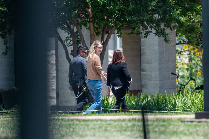 Elizabeth Holmes, founder of Theranos Inc., center, arrives at Federal Prison Camp Bryan in Bryan, Texas, US, on Tuesday, May 30, 2023. Holmes surrendered to authorities on Tuesday to begin her 11 1/4-year sentence after she was convicted by a jury last year of defrauding investors in the blood-testing startup. Photographer: Sergio Flores/Bloomberg via Getty Images