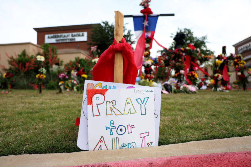 A sign asking people to "Pray for Allen, Texas," stands at a memorial to those killed at the Allen Premium Outlets mall after the mass shooting on May 8, 2023, in Allen, Texas.