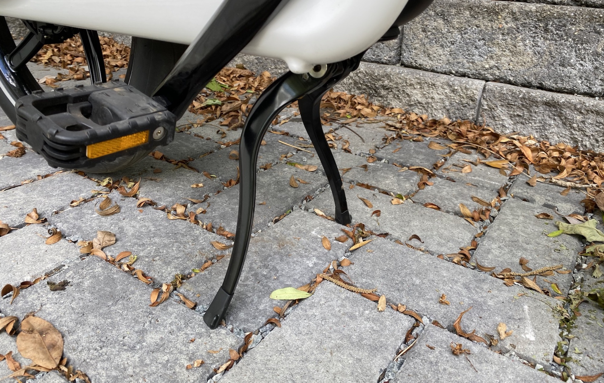 The kickstand spreads out when extended, keeping the bike upright even when the front wheel is folded next to the rear wheel.