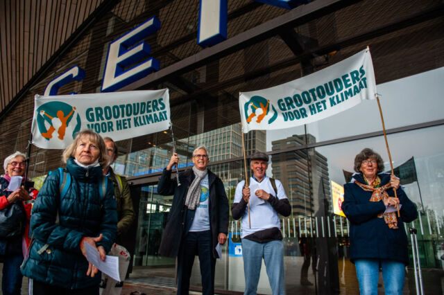 A climate-change lawsuit brought by the nonprofit Urgenda Foundation and hundreds of Dutch citizens ended in victory for the plaintiffs in 2019. The courts ordered the Dutch government to set more ambitious climate targets. In this photo, Grandparents for the Climate members are seen outside of the station in Rotterdam, Netherlands holding placards to support the Climate Miles walkers