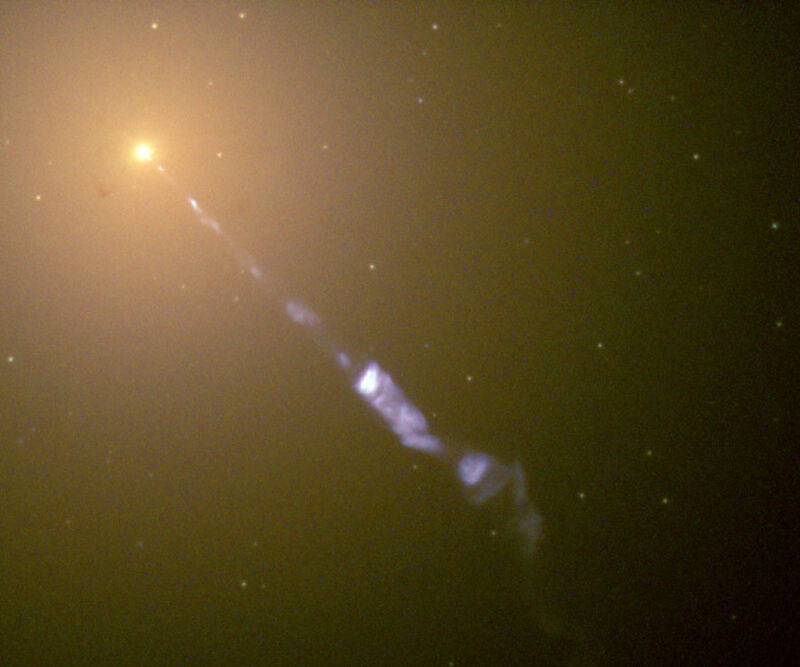 Image of a bright object in the upper left, with a stream of material projected towards the lower right.