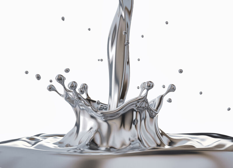 Image of a metallic liquid being poured, creating a ring of splashing material.