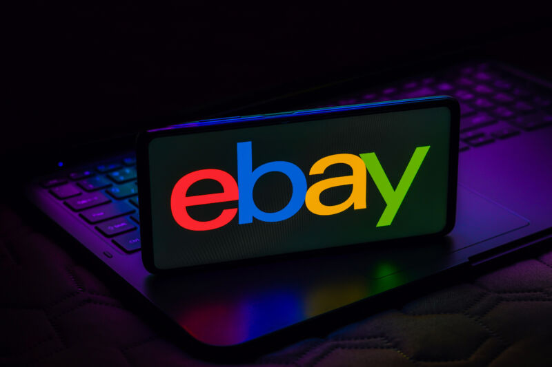 The eBay logo is displayed on a phone