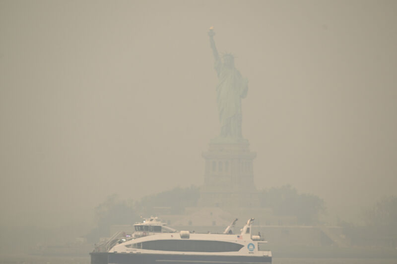The Downtown Manhattan skyline stands shrouded in a reddish haze as a result of Canadian wildfires on June 6, 2023.