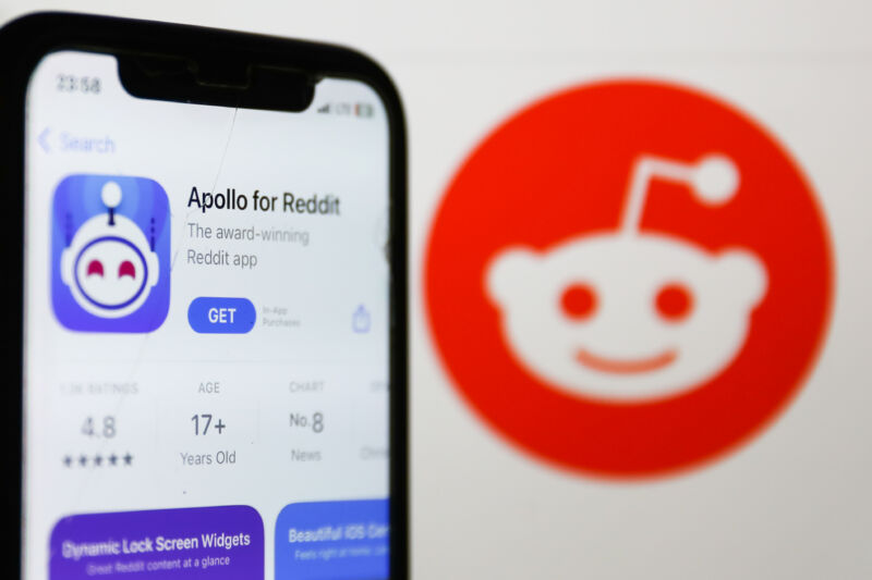 Apollo for Reddit on AppStore displayed on a phone screen and Reddit logo on the website displayed on a screen
