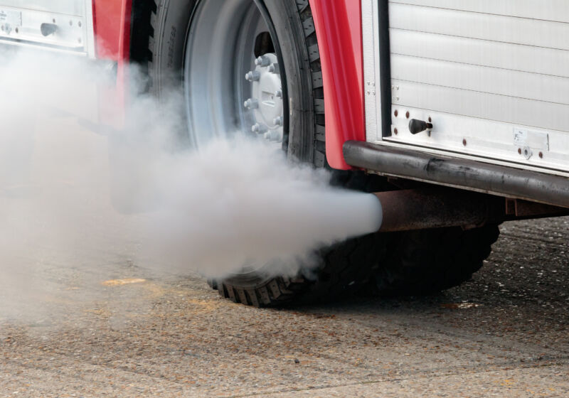 Image of exhaust coming out of the tailpipe of a bus.
