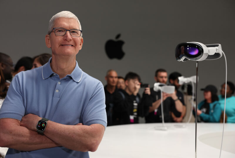 CUPERTINO, CALIFORNIA - JUNE 05: Apple CEO Tim Cook stands next to the new Apple Vision Pro headset that is displayed during the Apple Worldwide Developers Conference on June 05, 2023 in Cupertino, California. Apple CEO Tim Cook kicked off the annual WWDC23 developer conference with the announcement of the new Apple Vision Pro mixed reality headset.