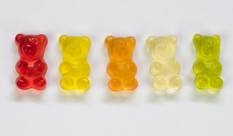 A row of different colored gummy bears.