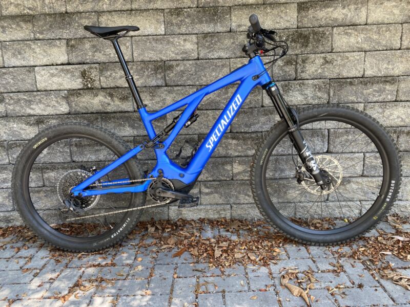 Image of a mountain bike leaned against a stone wall.