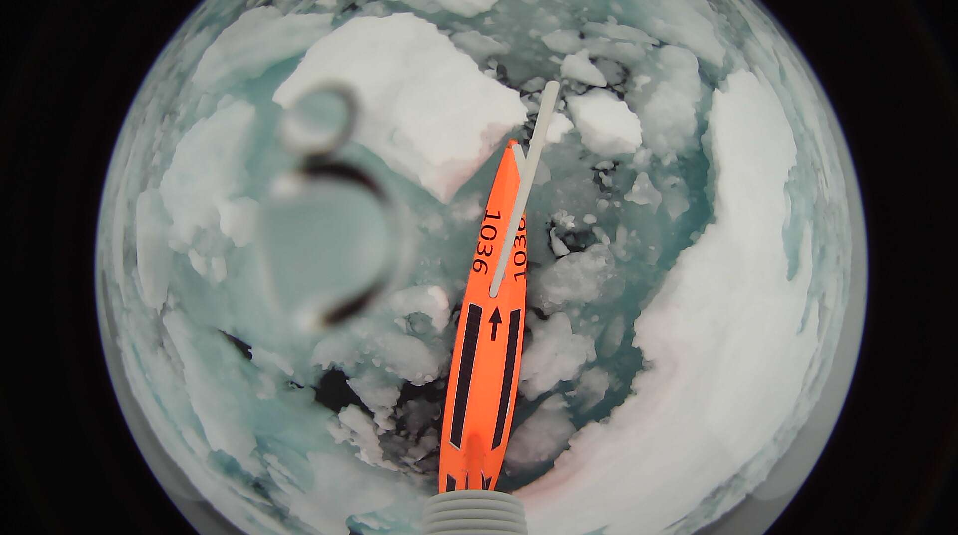 View down the wing to the sail drone, showing it surrounded by ice.