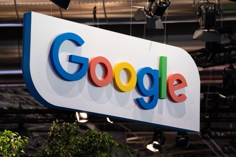 The Google logo on a large sign at a tech fair.