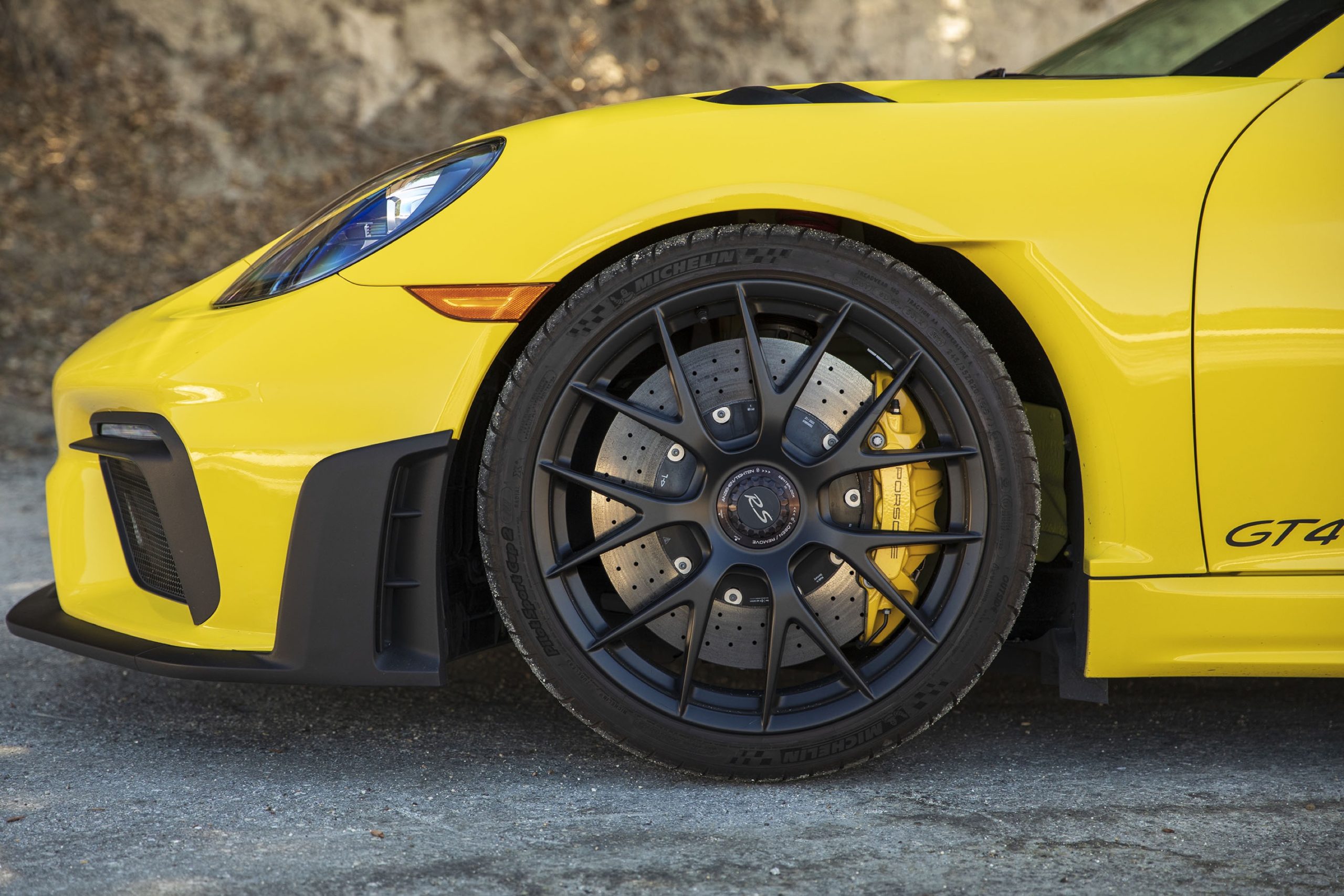 A yellow Porsche Cayman GT4 RS front wheel and fender