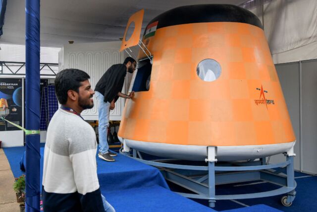 Visitors look at an actual scale model of India's Gaganyaan Orbital Module, a human-rated spacecraft now in development, at the Human Space Flight Expo in 2022.