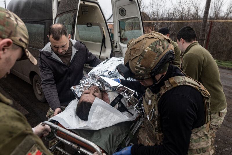 Ukrainian medics of the battalion "Da Vinci Wolves" and "Ulf" paramedical unit transfer a wounded Ukrainian soldier to a stabilization point on the Bakhmut front as the Russia-Ukraine war continues on April 6, 2023. 