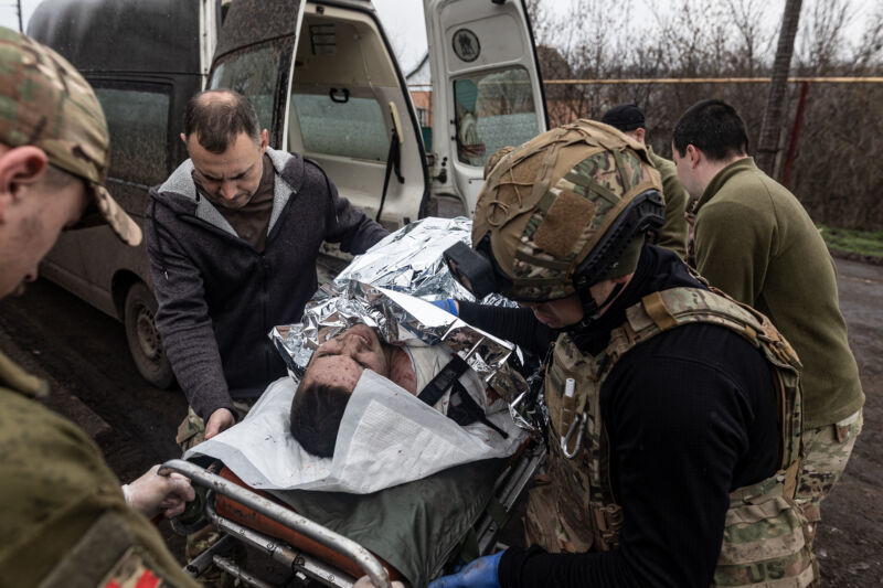 Ukrainian medics of the battalion "Da Vinci Wolves" and "Ulf" paramedical unit transfer a wounded Ukrainian soldier to a stabilization point on the Bakhmut front as the Russia-Ukraine war continues on April 6, 2023.