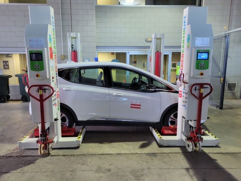 a white Chevrolet bolt on a four post lift