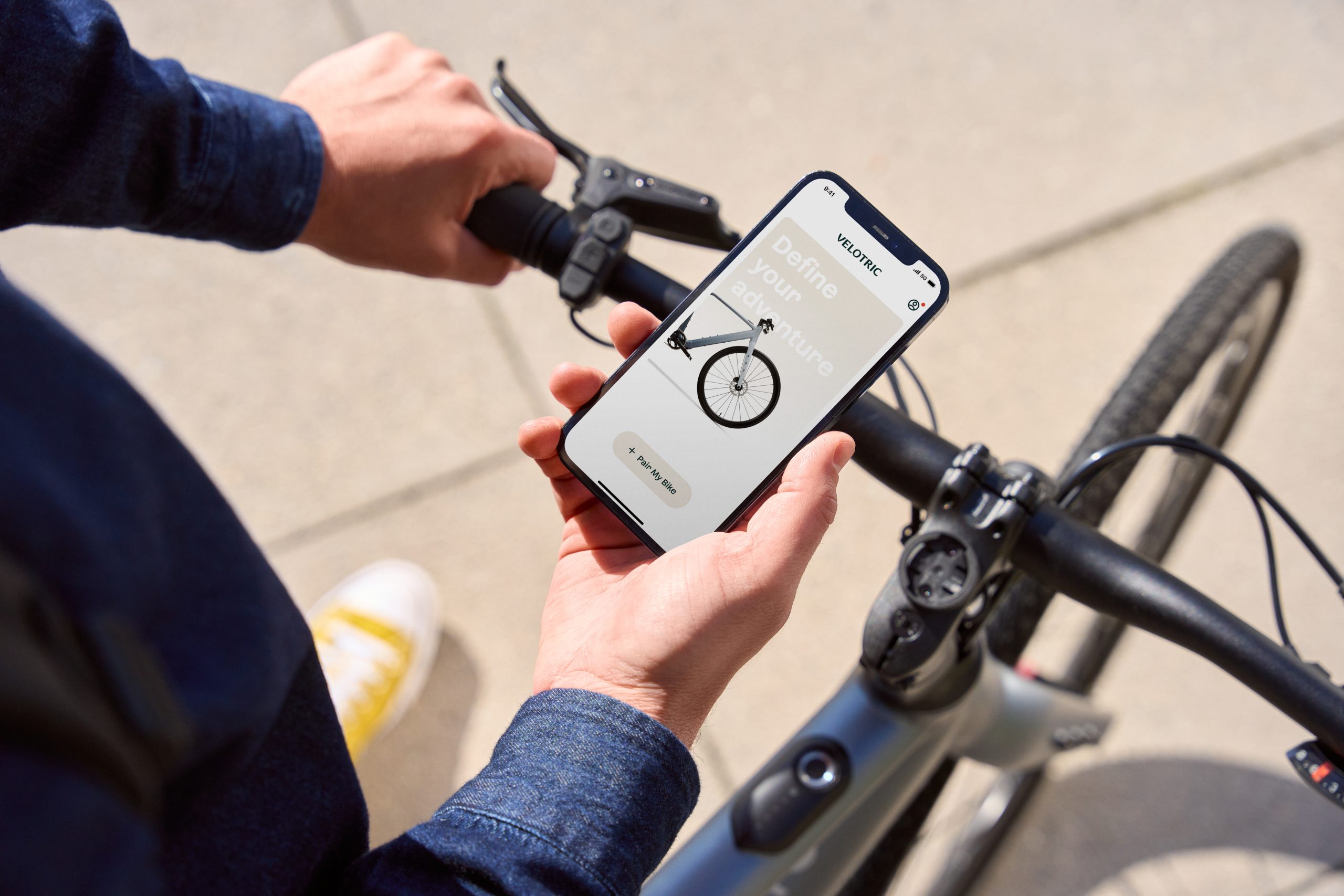 Person holding Velotric app over the T1 bike
