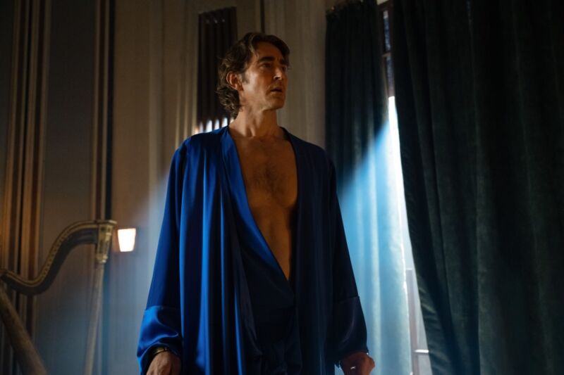 Lee Pace in long blue rob wth plunging vee neck