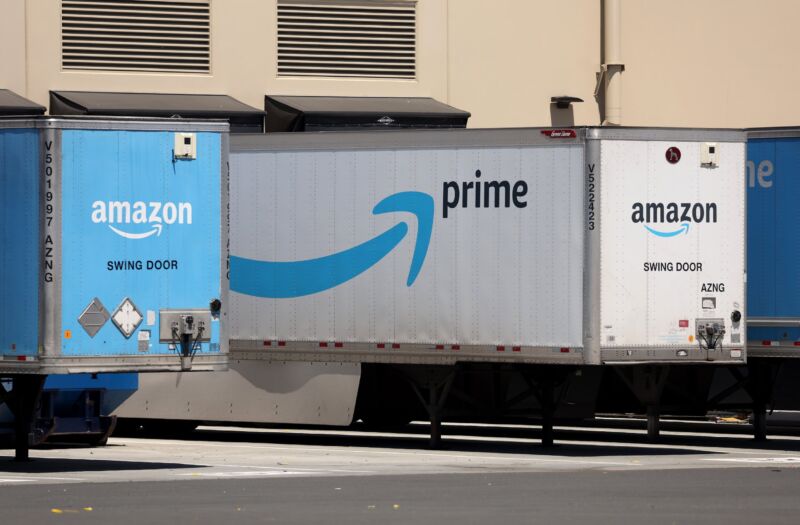 Amazon logos displayed on two large trucks.