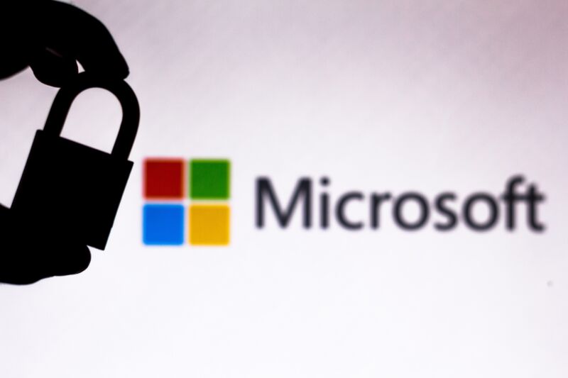 In this photo illustration a padlock appears next to the Microsoft Corporation logo