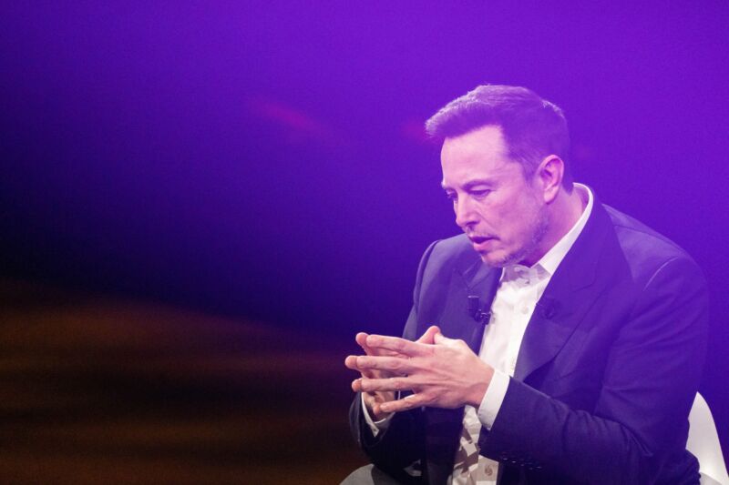 Elon Musk speaking at a tech event.