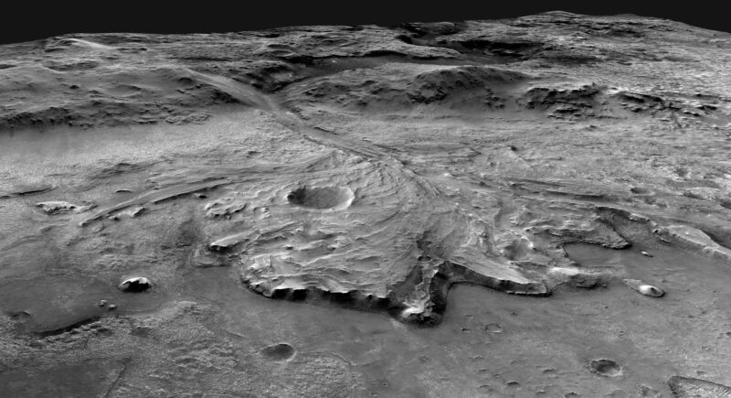Greyscale image of a large fan of material spread out across a crater floor.