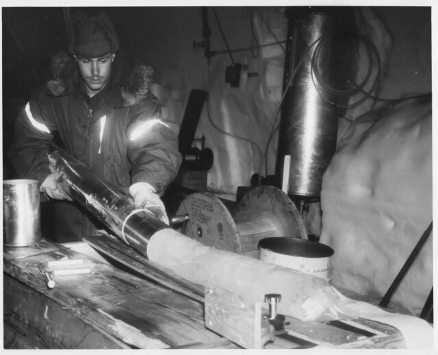 George Linkletter, working for the US Army Corps of Engineers Cold Regions Research and Engineering Laboratory, examines a piece of ice core in the science trench at Camp Century. The base was shut down in 1967.